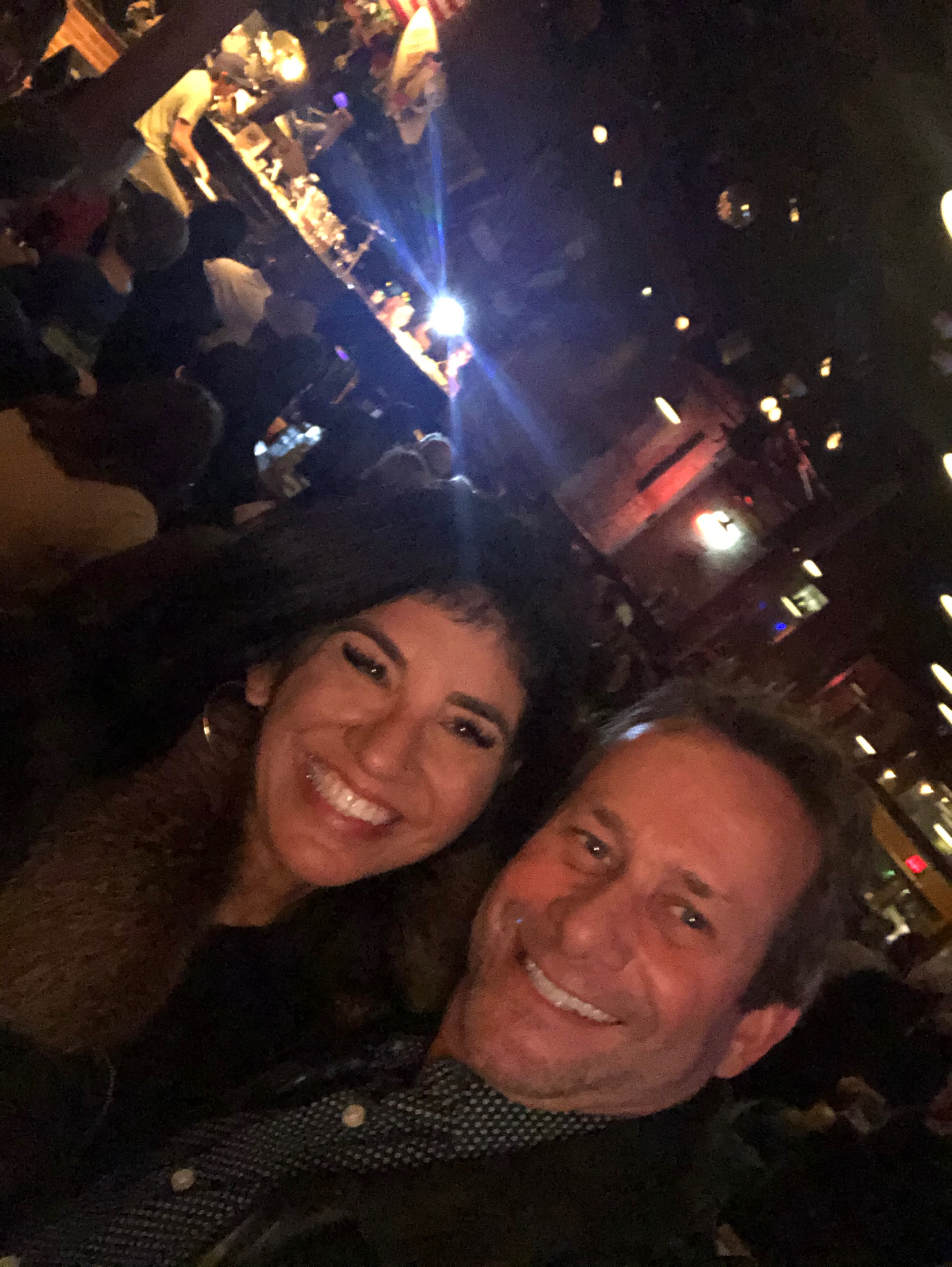 David and Kandi smiling in a lively bar