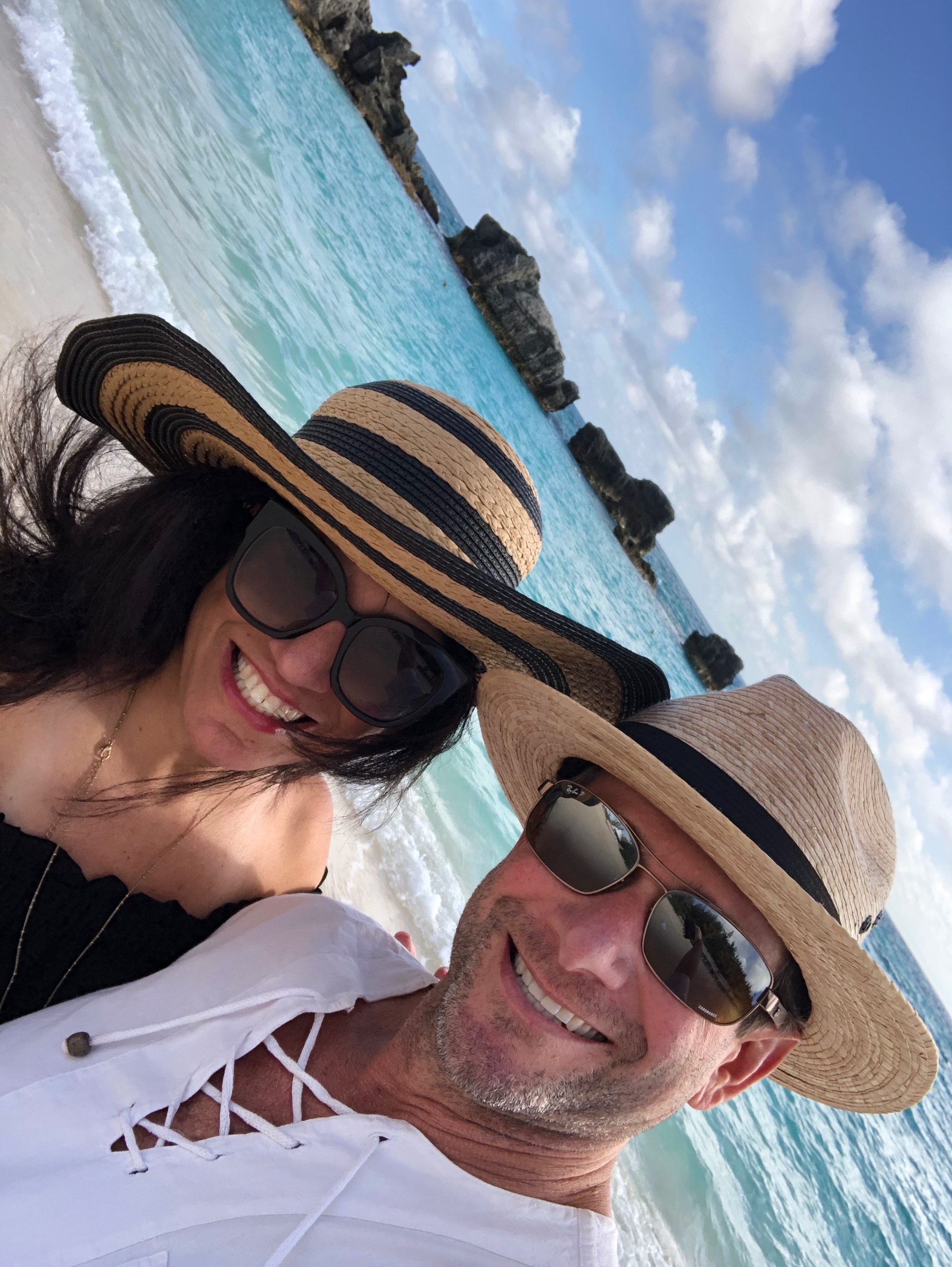 David and Kandi in straw hats at the beach